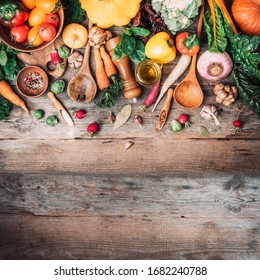 Organic food. Harvest of fresh vegetables on wooden background. Top view. Copy space. Diet or vegetarian food concept. Assortment of churd, pumpkin, carrot, pepper, cabbage, garlic, tomatoes.