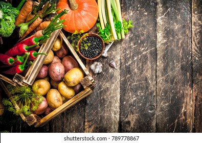 Organic food. Harvest of fresh vegetables in old boxes. On a wooden table.