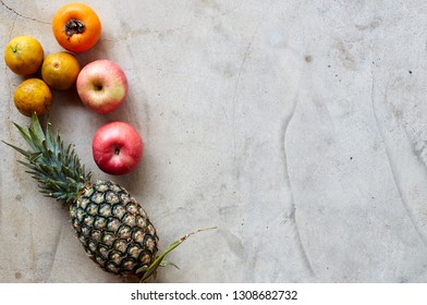 Organic fresh fruits frame on a gray concrete background, clean eating concept. Top view, copy space - Powered by Shutterstock