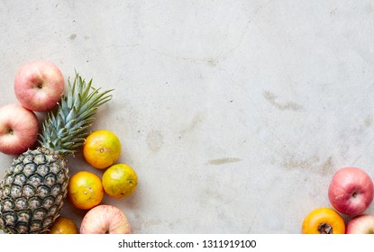 Organic fresh fruits frame on a gray concrete background, clean eating concept. Top view, copy space - Powered by Shutterstock