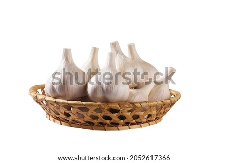 organic garlic bulbs in a basket isolated on white background.