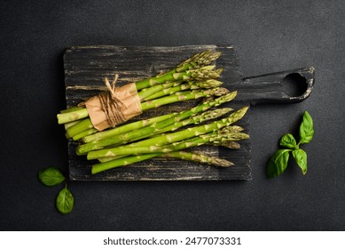 Organic green asparagus on a wooden board. Healthy food. Top view. - Powered by Shutterstock