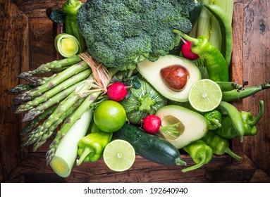 Organic Green Vegetables And Fruits On Dark Wooden Background.Healthy Food.