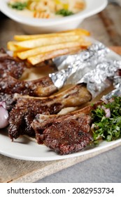 Organic Grilled Lamb Chops With Garlic, French Fries,  And Lime
