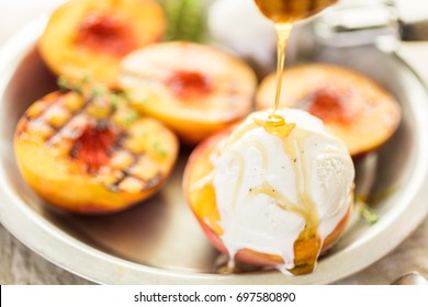 Organic grilled peaches with vanilla ice cream and honey.