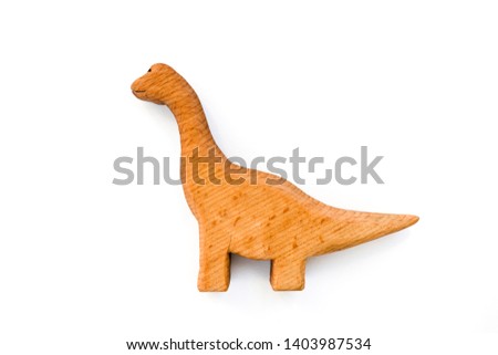 Organic hand made wooden dinosaur toy isolated on white background. Environment friendly natural stuff. Ecological lifestyle. Baby care and childhood concept. Trendy element for design mock-up.