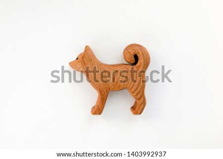 Organic hand made wooden dog toy isolated on white background. Environment friendly natural stuff. Ecological lifestyle. Baby care and childhood concept. Trendy element for design mock-up.