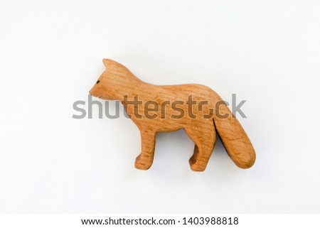 Organic hand made wooden fox toy isolated on white background. Environment friendly natural stuff. Ecological lifestyle. Baby care and childhood concept. Trendy element for design mock-up.