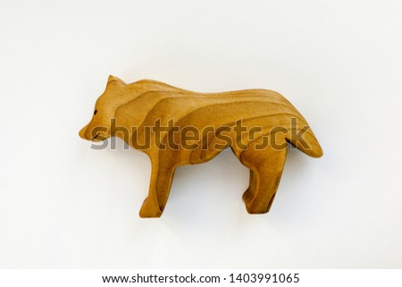 Organic hand made wooden wolf toy isolated on white background. Environment friendly natural stuff. Ecological lifestyle. Baby care and childhood concept. Trendy element for design mock-up.