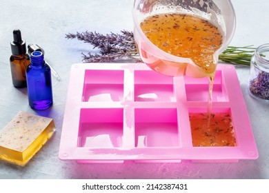 Organic Handmade Soap, The Process Of Making. Liquid Glycerin With Lavender Flowers And Essential Oils Poured Into A Mold To Later Form Into Bars