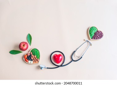 Organic  Healthy  Food  In  Wooden  Bowls , Red  Heart  Shape ,medical  Stethoscope  And  An  Apple  On  Pastel  Background  For  The  Health  Concept