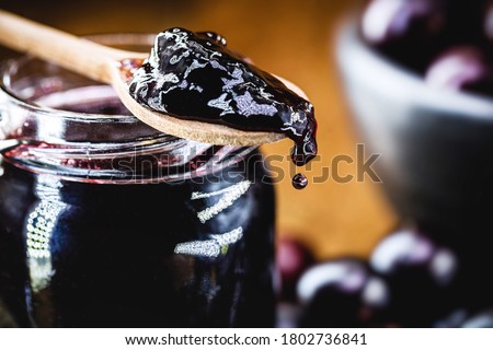 organic jelly made in a wooden spoon, jabuticaba (or jaboticaba) jelly, a typical Brazilian fruit, known as Brazilian grape, dripping drop of tasty candy