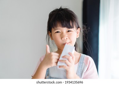 Organic Lactose Free Milk.Asian Kid Girl Drinking Milk.Calcium Vitamin From Milk.Grocery, Good Taste.Kid Drink.School Kid Girl, Healthy, Yoghurt, Mock Up Product.Delicious Tasty.Fruit Juice.vitamin C.