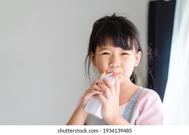 Organic lactose free milk.Asian kid girl drinking milk.Calcium vitamin from milk.Grocery, Good taste.Kid drink.School kid girl, Healthy, yoghurt, mock up product.Delicious tasty.Fruit juice.vitamin C.