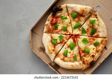 Organic Margarita Pizza With Basil And Mozarella In A Box, Top View. Flat Lay, Overhead, From Above.