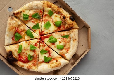 Organic Margarita Pizza With Basil And Mozarella In A Box, Top View. Flat Lay, Overhead, From Above.