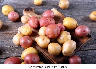 Organic mixed baby potatoes on wooden cutting board - Powered by Shutterstock