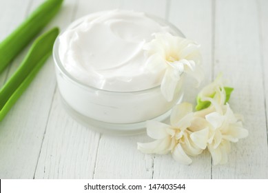 organic moisturizer creme on white wood 