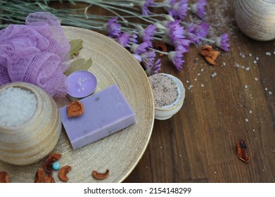 Organic natural soap, spa handmade artisan cosmetics with lavender, candle on golden plate and wooden background