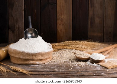Organic Natural Whole Grain Flour in Sacks and wheat seeds Ears of wheat on an old wooden floor