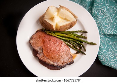 organic prime rib roast dinner with baked potato and asparagus - Shutterstock ID 1867725784