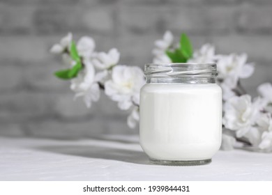 Organic Probiotic Milk Kefir Drink Or Greek Yogurt In Glass Jar,on The White Grey Background. Gut Health. Probiotic Cold Fermented Dairy Drink. Trendy Food And Drink. Copy Space