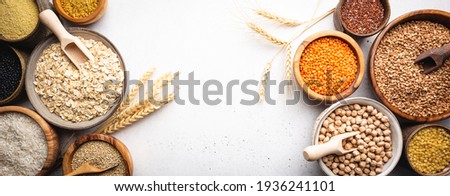 Organic products. Bowls with different gluten free grains on white background, top view
