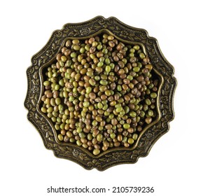 Organic raw green beans mungo (Vigna radiata) in embroidered metal bowl isolated on white, top view