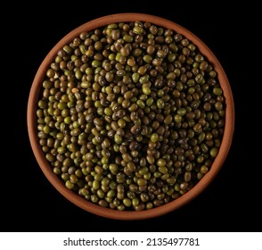 Organic raw green beans mungo in clay pot (Vigna radiata) isolated on black, top view