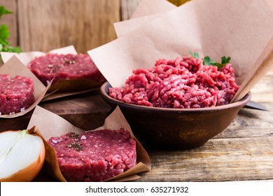Organic Raw Ground Beef Meat And Burger Steak Cutlets Ready To Prepare On Rustic Table 