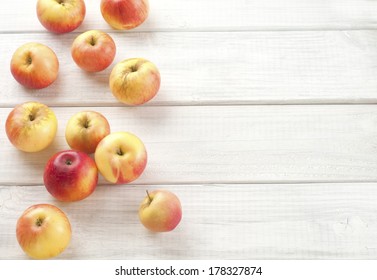 Organic Red Akane Apples, Sweet And Tart Fresh Picked From The Tree On White Wood Boards For A Background With Room Or Space For Copy Or Your Words Or Text.   Top View Looking Down From Above.