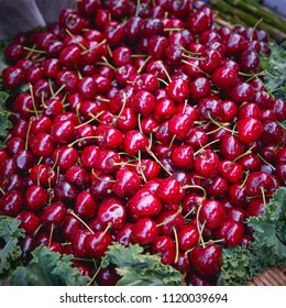 Organic Red Cherries In A Wooden Punnet On Sale At A Stall In A Local Farmer Market. Seasonal Food. Square Format.