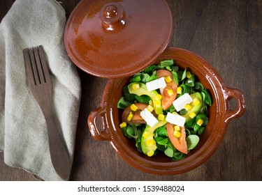 Organic Salad Leaves: Arugula, Watercress, Lettuce, Corn And Tomato In A Crock Pot. Close Up. Healthy Food Concept.