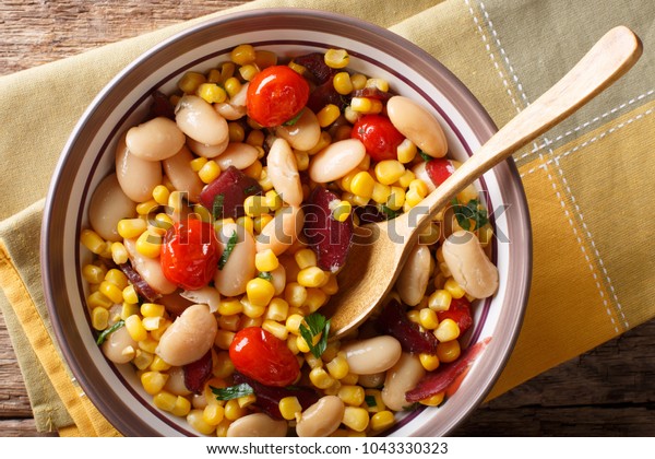 organic salad succotash from the butter beans,\
tomatoes and bacon close up in a bowl on the table. horizontal top\
view from above\
