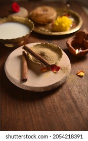 Organic sandalwood and spiced herbal powder for special therapeutic bath on special occasions like Diwali festival or weddings. Diwali 'Abhyang Snan' ritual background.
