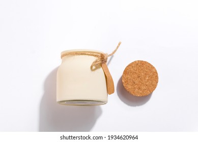 Organic scented soy candle with label and shadow on white background