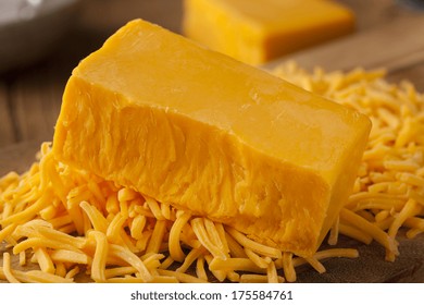 Organic Sharp Cheddar Cheese On A Cutting Board