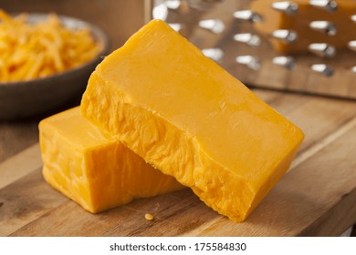 Organic Sharp Cheddar Cheese On A Cutting Board