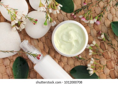 
Organic skin care products with fresh flowers and stones, top view on straw mat. Jar of cream natural set.  - Shutterstock ID 1012000708