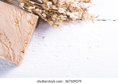 organic soap with a bunch of dried lavender flowers on white wood background - Shutterstock ID 367109279