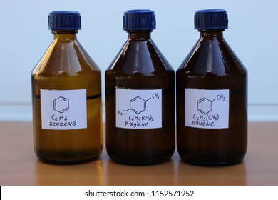 Organic solvents in dark glass bottles: benzene, p-xylene, toluene.