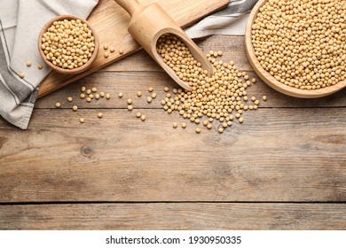 Organic soy beans on wooden table, flat lay. Space for text