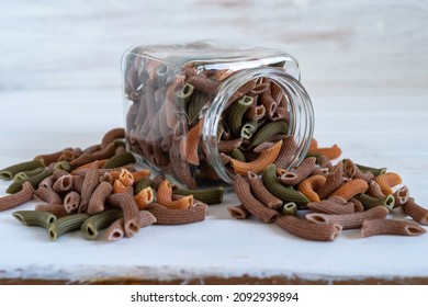 Organic Spelt Tricolor Pasta in glass jar over white wooden background. - Powered by Shutterstock