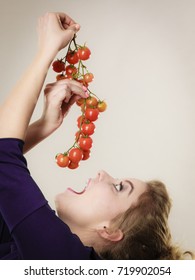 Organic vegetables and food concept. Happy positive smiling woman holding fresh cherry tomatoes