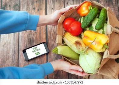 Organic Vegetables and fruits in cotton bag and tablet pc with copy space, online market, green grocery delivery at home concept - Powered by Shutterstock