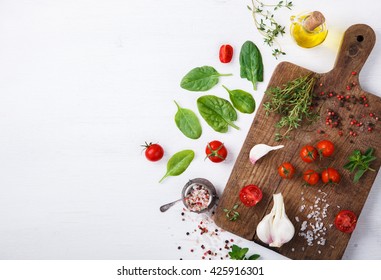 Organic vegetarian ingredients, olive oil and seasoning on rustic wooden cutting board over dark vintage background with space for text.Healthy food, or diet nutrition concept.Fresh Vegetables - Shutterstock ID 425916301