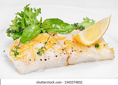 Organic White Fish Fillet Cooked With Fresh Green Salad Leafs And Lemon Isolated On White Background Of Plate