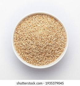 Organic White Sesame seeds(Sesamum indicum) or white Til with shell in white ceramic bowl