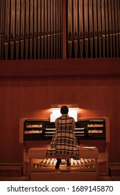 Organist Playing A Pipe Organ