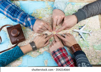 Organization Of Group Travel. Desk Travel Agency. Six Friends Are Going To Visit Bavaria Germany Munich. Top View. Map And Camera.